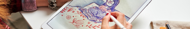 A women drawing a illustration on a Tablet
